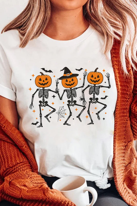 Person wearing a white t-shirt with Halloween-themed skeleton and pumpkin design, sitting with a cup of coffee.