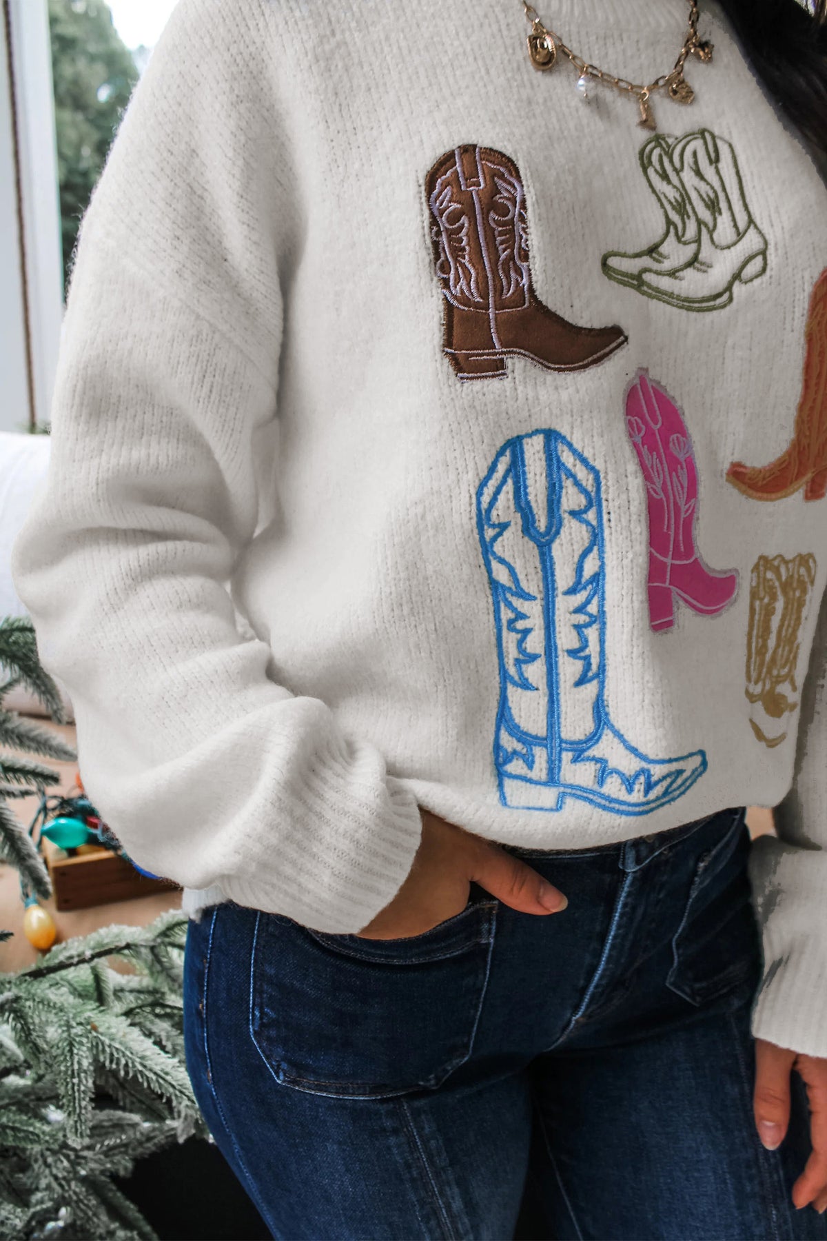 Women's soft knit Western sweater with colorful embroidered cowboy boot designs and ribbed cuffs
