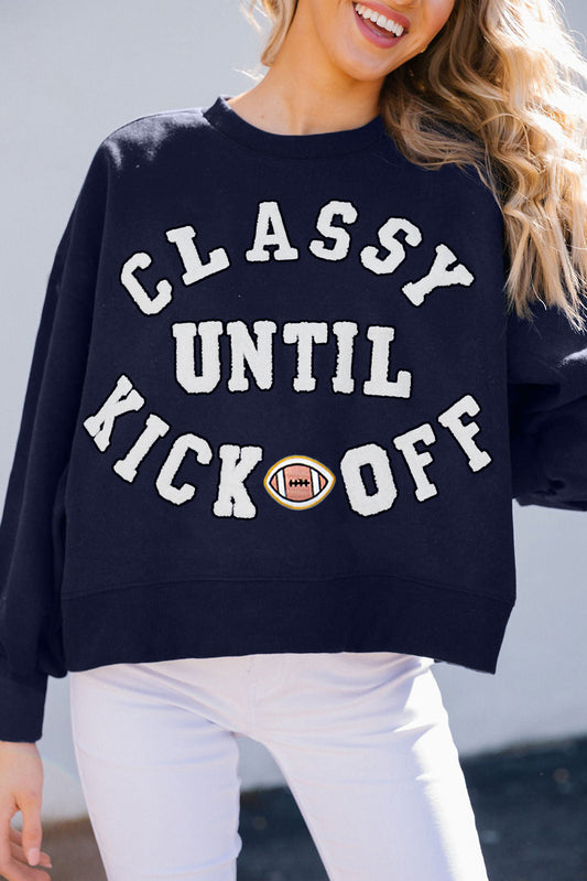 Person wearing a navy blue sweatshirt with 'Classy Until Kick Off' text and football graphic.